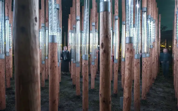 Man walking through a series of large glass tubes made with SCHOTT CONTURAX® and DURAN® glass