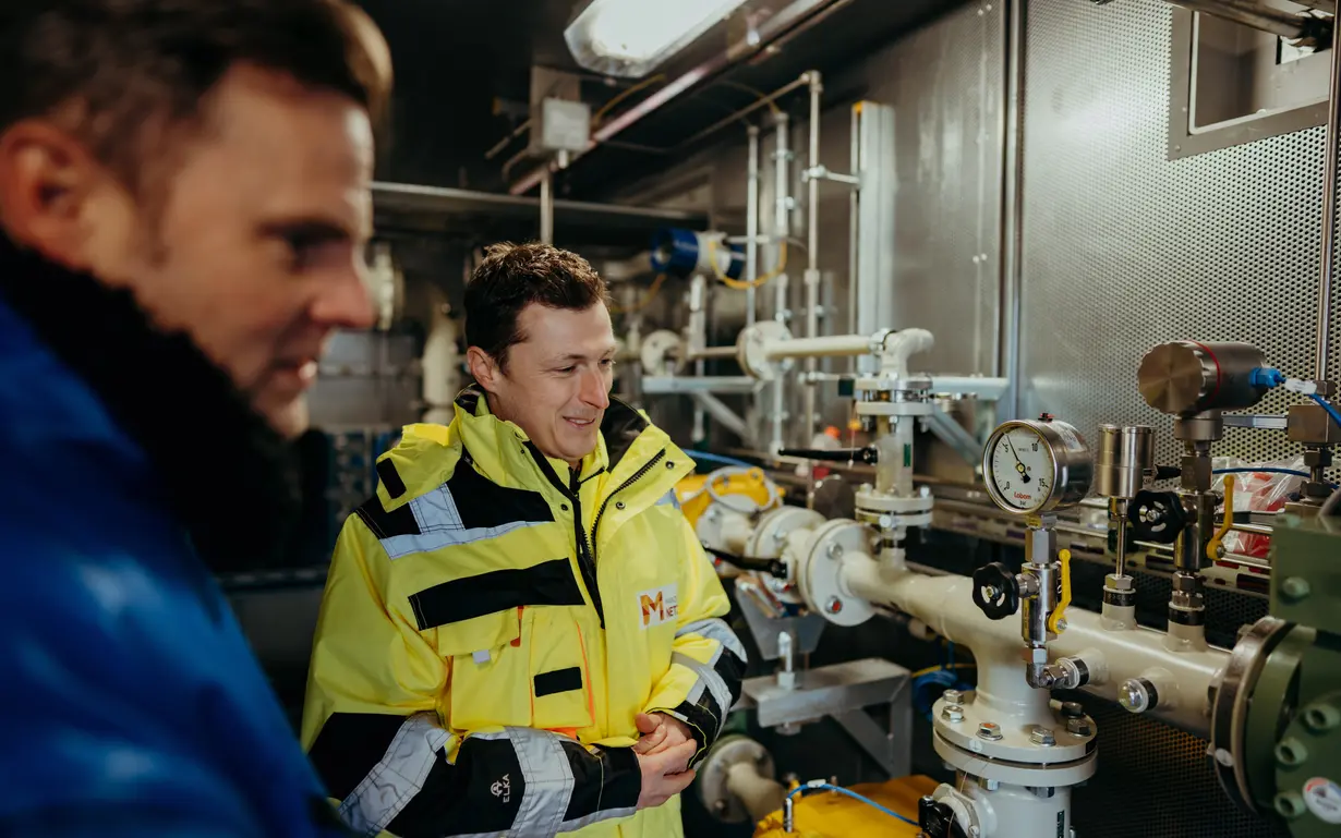 Two men at the laboratory test experiments with hydrogen