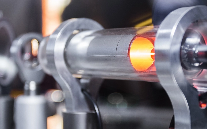 Orange laser light in glass laboratory tubing