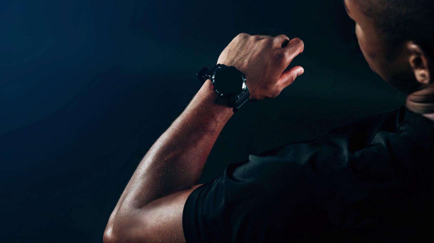 Athlete looking at his smart watch