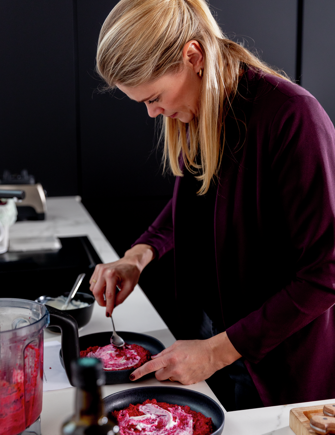 Woman arranges beet puree on plates