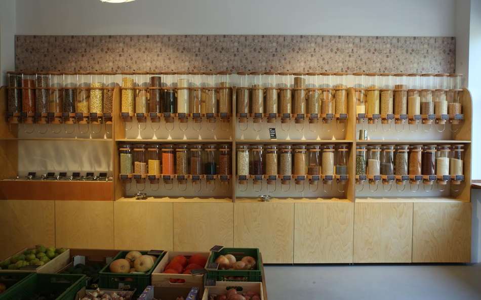 Wall inside a hawos store, featuring two rows of glass food containers