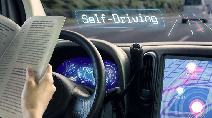 Passenger reading a book in an autonomous vehicle