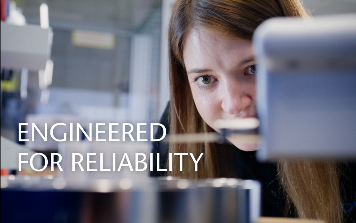 Technician inspects dimensions of a large feedthrough with precision instrumentation