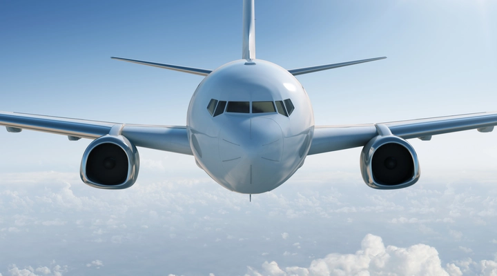 Front view of an aircraft in a blue sky