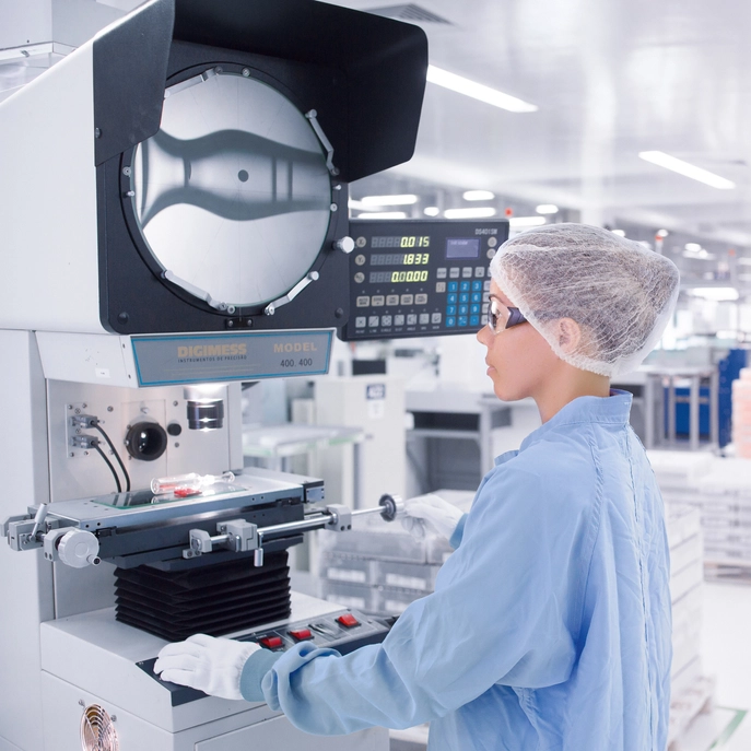 Laboratory scientist examines glass pharmaceutical packaging