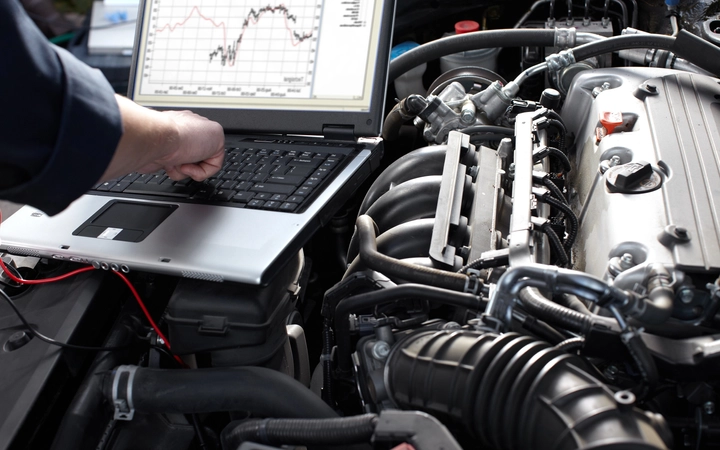 A engineer is monitoring the situation of car engine system