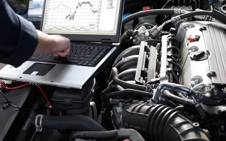 A engineer is monitoring the situation of car engine system