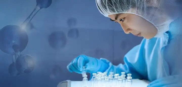 Laboratory technician examining a vial