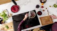 Kitchenette with glass-ceramic hob and various cooking ingredients