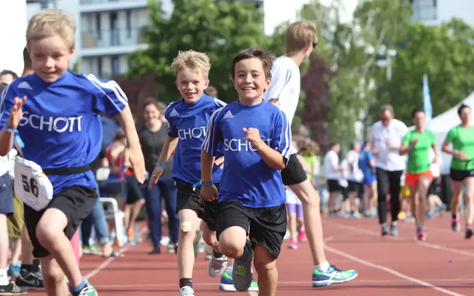 Young children in SCHOTT t-shirts in a running race