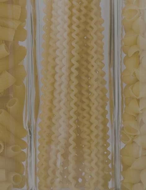 Glass tubes full of different types of pasta