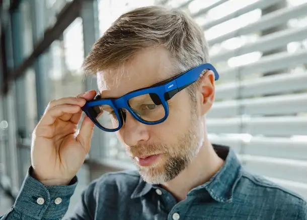 Man wearing Lumus smart glasses with SCHOTT reflective waveguides