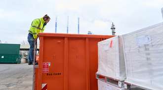 Marius Amschler looks into a container to check the storage of the Fiolax medication vials	