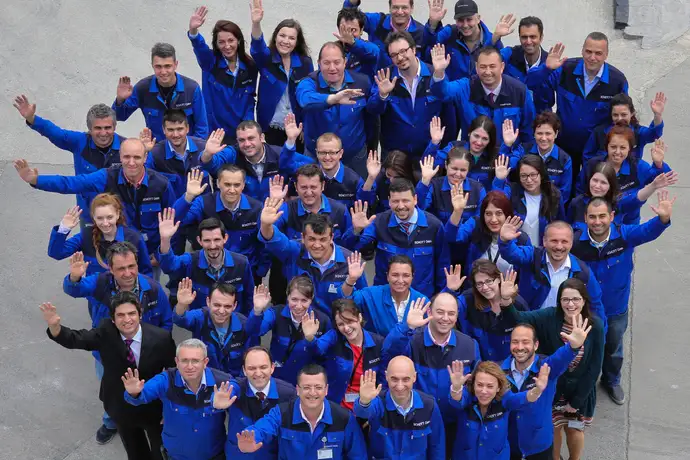 Group of SCHOTT employees waving outdoors