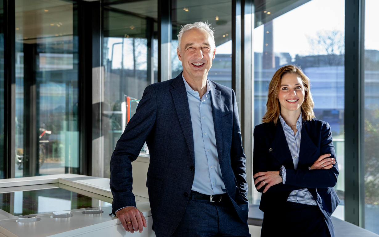 CEO and CFO of SCHOTT Pharma standing in a conference room leaning on a desk