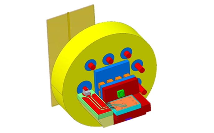 A schematic representation of a mechanical assembly with a circular yellow main structure, connectors, and various colored components.