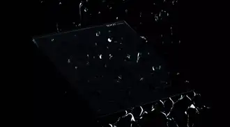 Dark glass panel with a special coating with scattered water droplets highlighting the waterproof design.