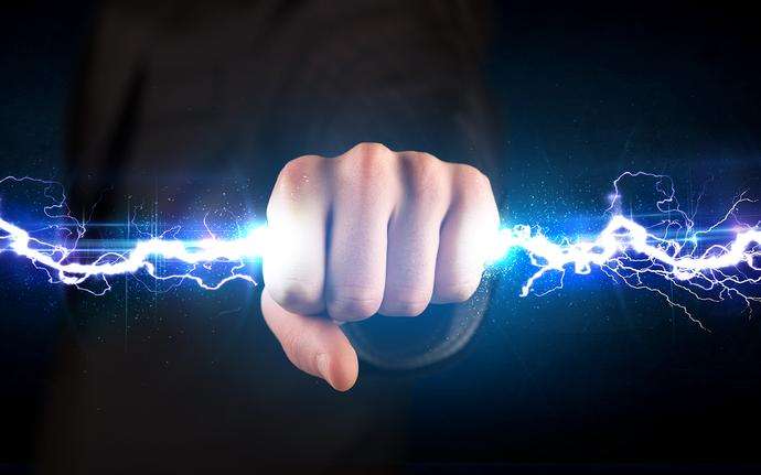 A hand holding an electrical bolt.