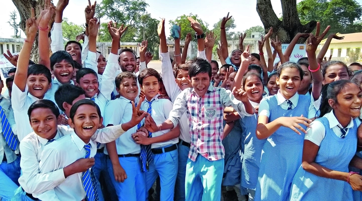 Group of young school children smiling for camera