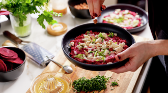 Beet puree is garnished with herbs