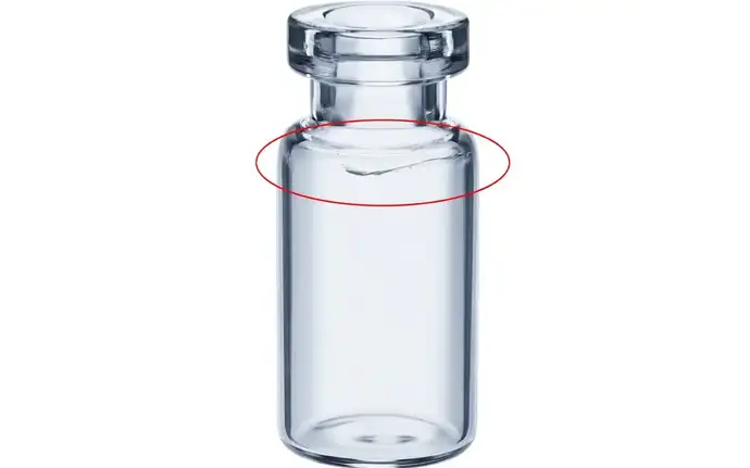 The wall penetrating crack in the shoulder area of the vial could result in loss of container closure integrity.