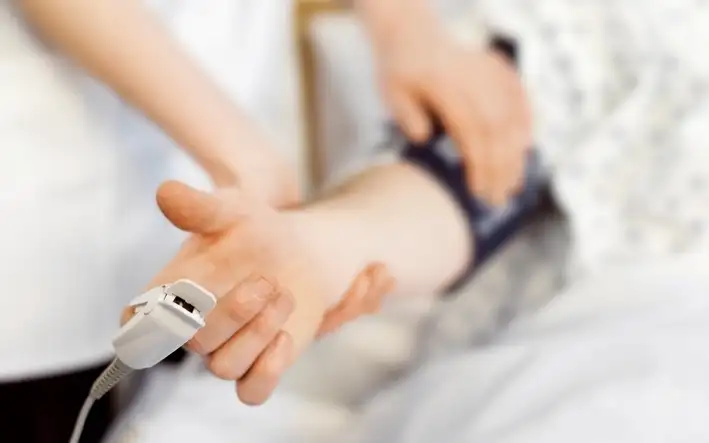 Nurse helping a patient using wearables to monitor physical condition