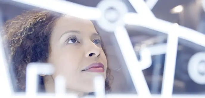 Female looking at illuminated lines on glass panel