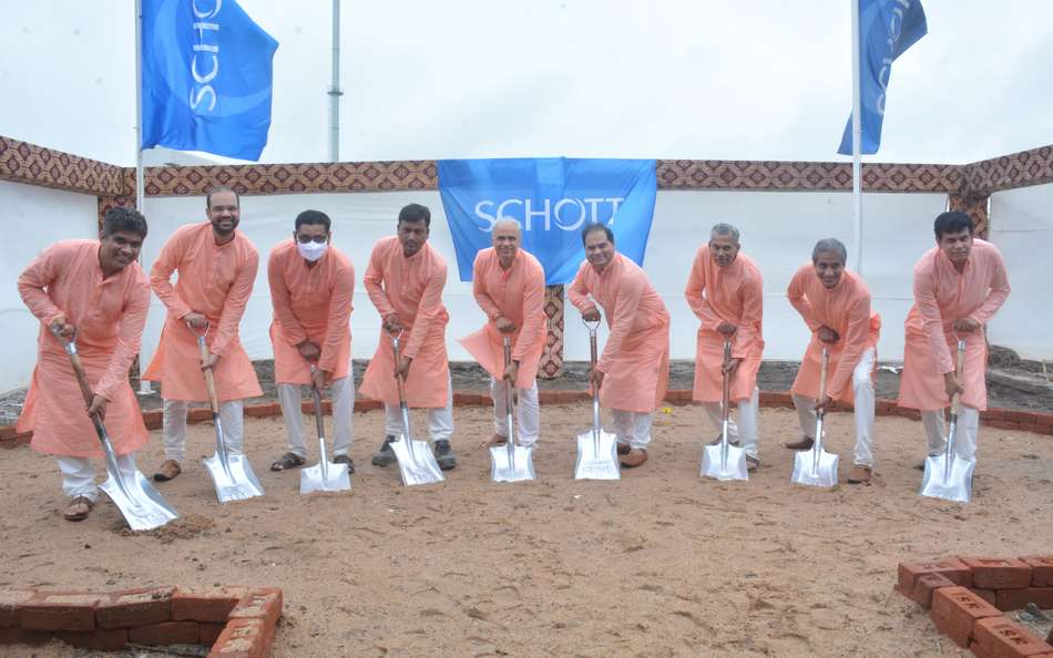 Nine men holding spades in a groundbreaking ceremony for a new SCHOTT plant in Jambusar, India