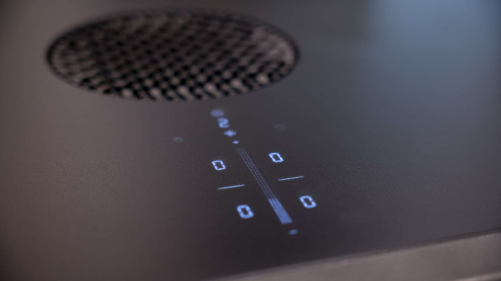 CERAN® cooktop with downdraft and touch control panel, modern matte black glass-ceramic design with precise LED displays.