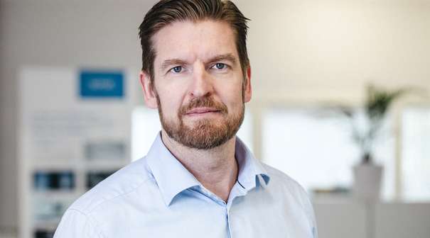 Headshot of Antti Peltonen in a blue shirt.