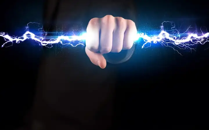 A hand holding an electrical bolt.