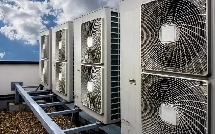 Four white outdoor industrial air conditioning units