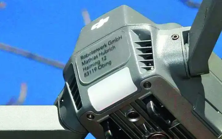 Close up of the body of a drone with engraved registration plate