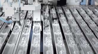 The glass tubes are machine-formed into medicine vials in long rows	