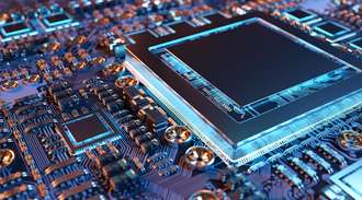 Close up of a circuit board with semiconductor in blue light