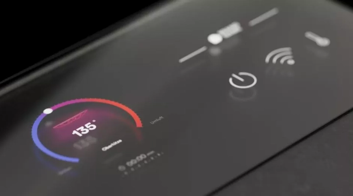 Close-up of a modern glass touch control panel showing a temperature setting of 135° with a colorful circular gauge and icons for power, Wi-Fi, and temperature adjustment.