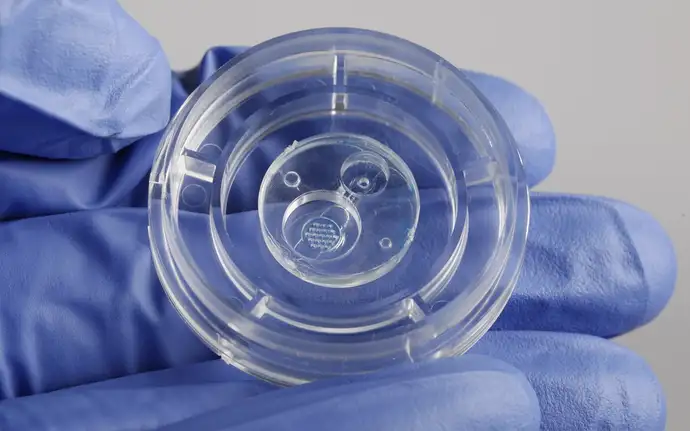 Injection molded part for microfluidic cartridge.