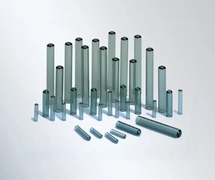 A display of gray glass tubes in various sizes.