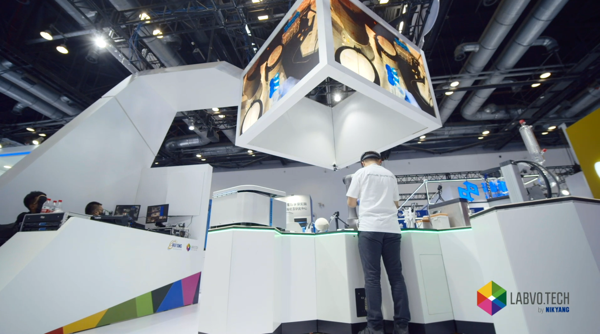 Scientist working underneath large display at trade show