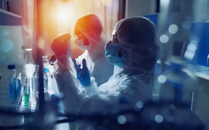 Scientists examine test tubes in laboratory