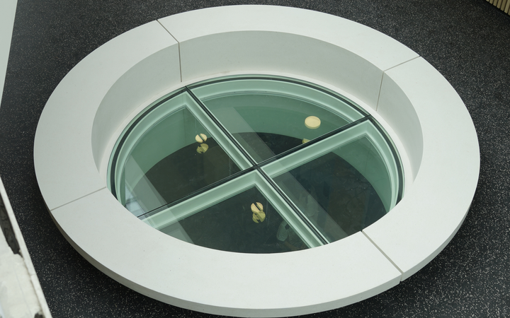 Circular glass floor in a building corridor
