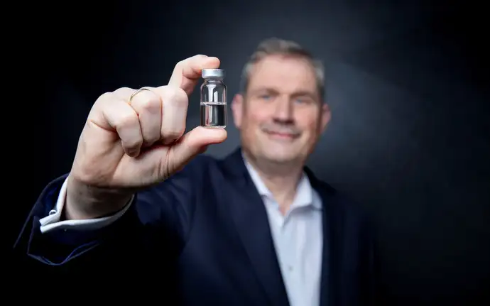 Man shows a pharmaceutical vial