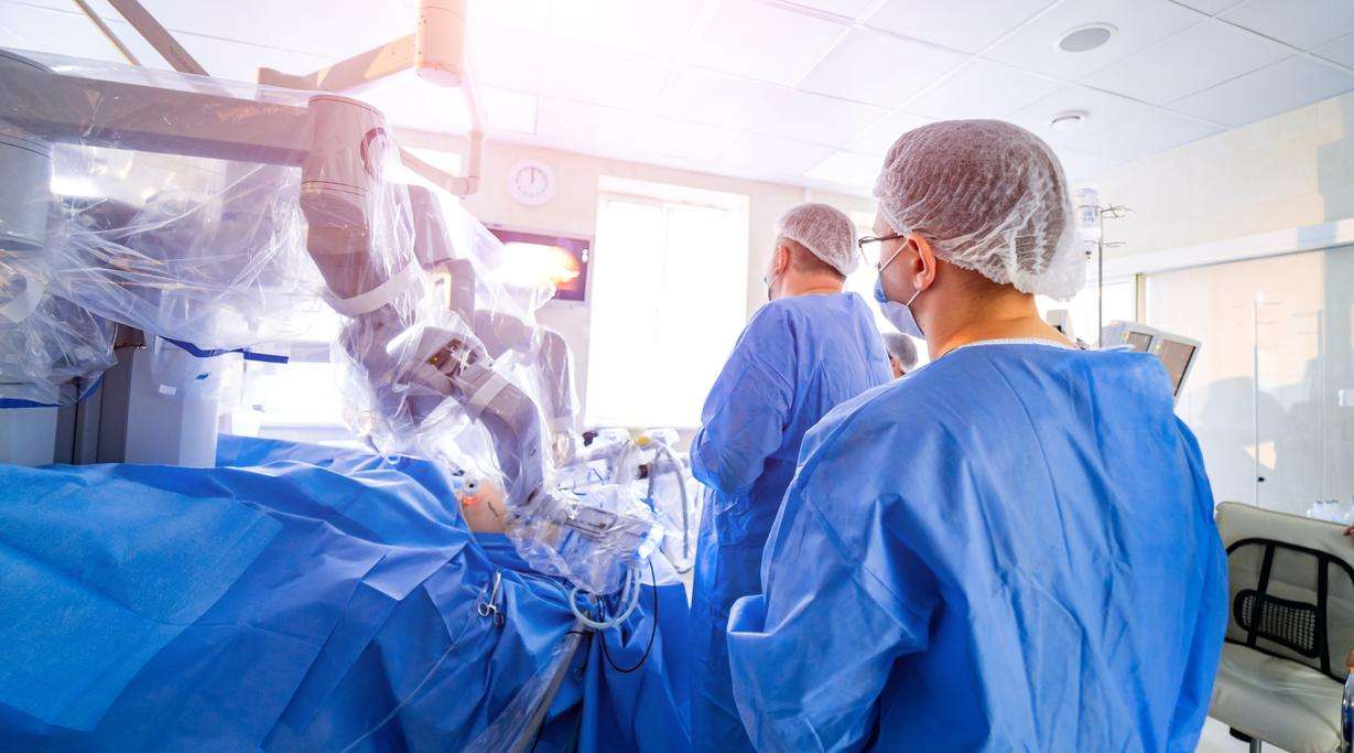 Two surgeons in an operating theater with robotic equipment
