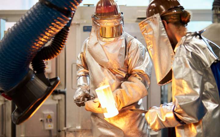 Melting lab with two workers pouring