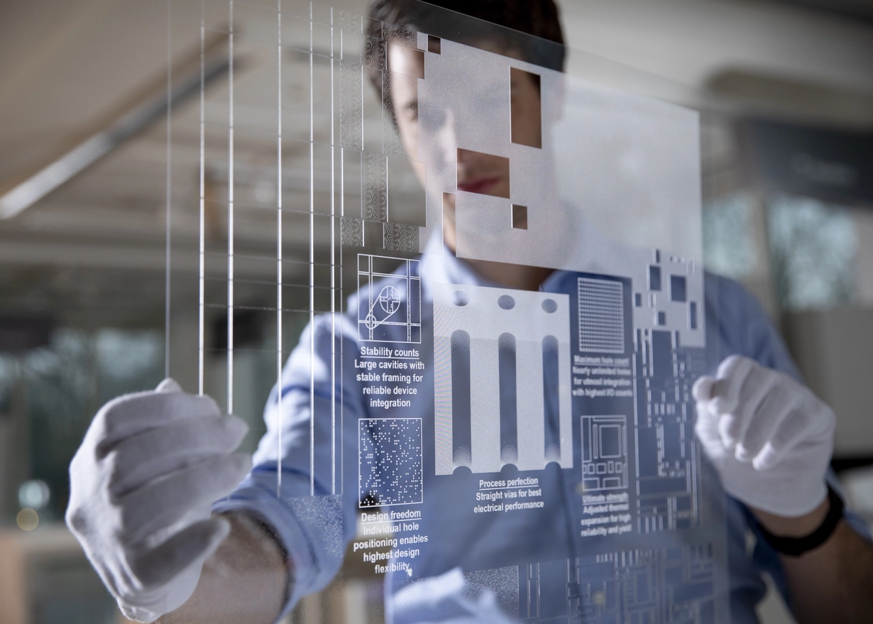 Man in gloves examining a panel of structured glass 