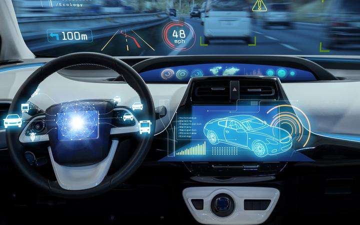 Interior of a vehicle showing the dashboard outlined in blue contour light
