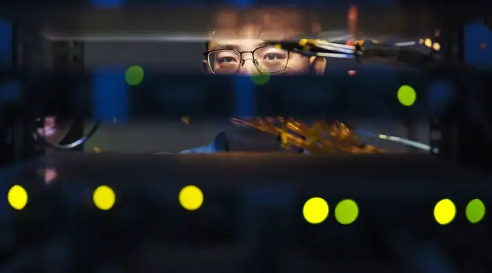 An IT engineer working on computer servers.