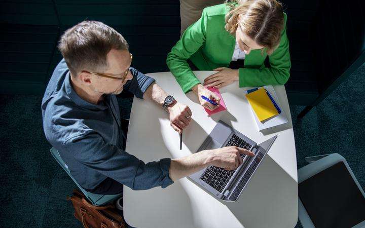 Woman and Man working together on a laptop