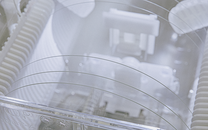 Close-up of mechanical components with translucent and ribbed elements under soft lighting.